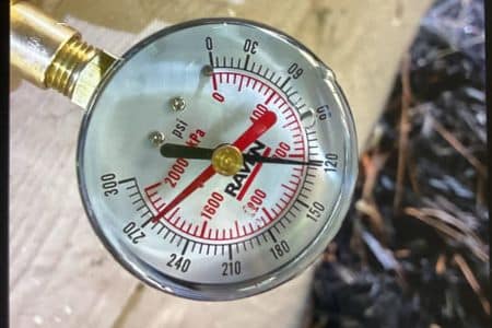 a pressure gauge shows high pressure at 120 psi - high pressure is one of the most common plumbing problems