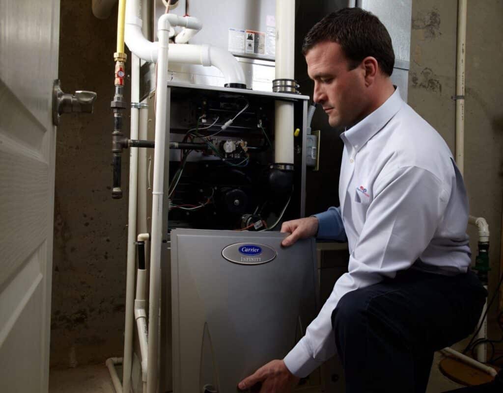 hvac inspection checklist - a tech removes the furnace cover