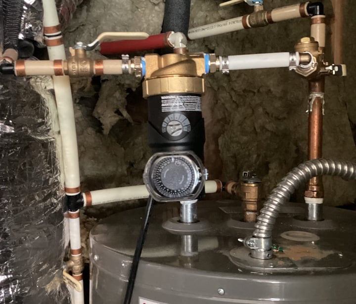 plumber in Suwanee, GA installs recirculation pump