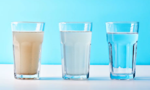 glass of dirty water cleaned with water filtration