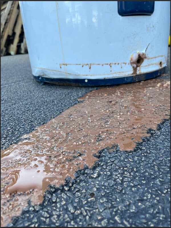Sediment buildup inside a water heater tank.