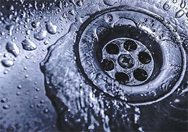 After performing drain cleaning, this drain is no longer clogged, water is draining.