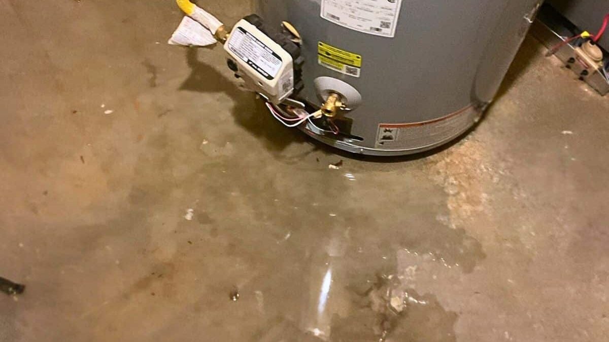 a water heater leaking from the bottom floods an unfinished basement