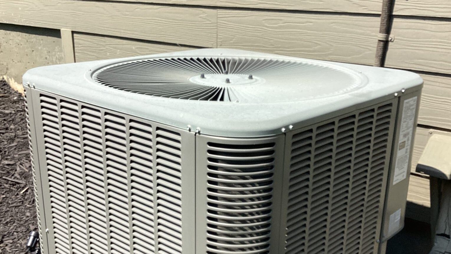 best time to buy an air conditioner shown with outdoor AC unit at a Georgia home