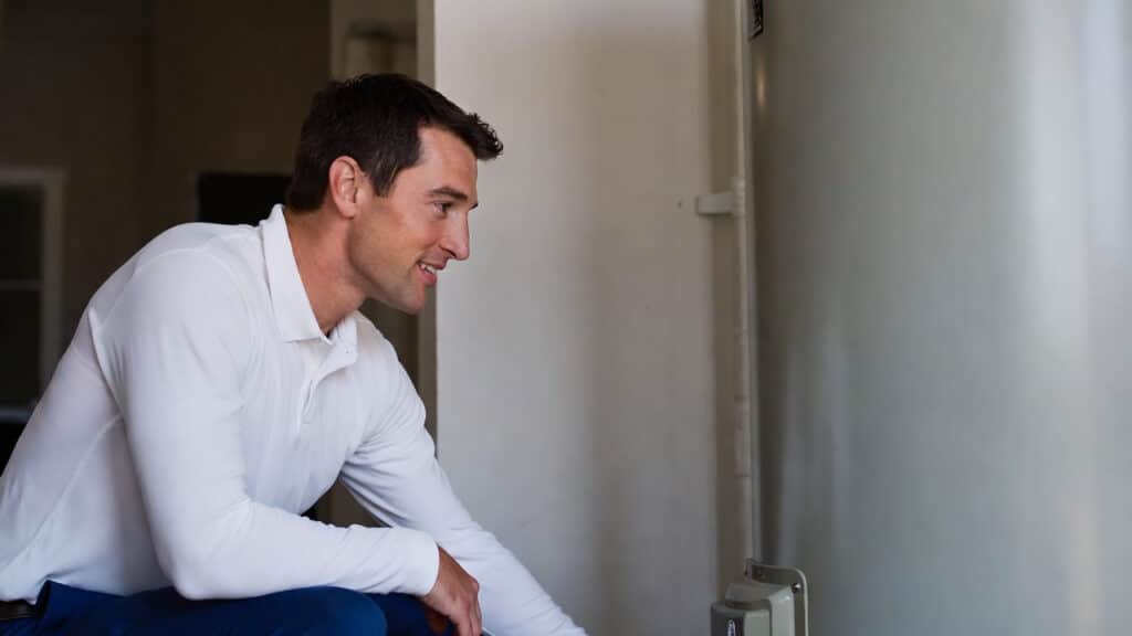 why is my water not getting hot? A plumber inspects a water heater to find the answer