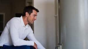 why is my water not getting hot? A plumber inspects a water heater to find the answer