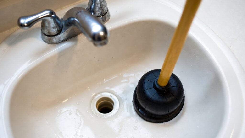 a plunger clears a clogged sink