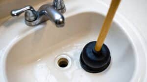 a plunger clears a clogged sink