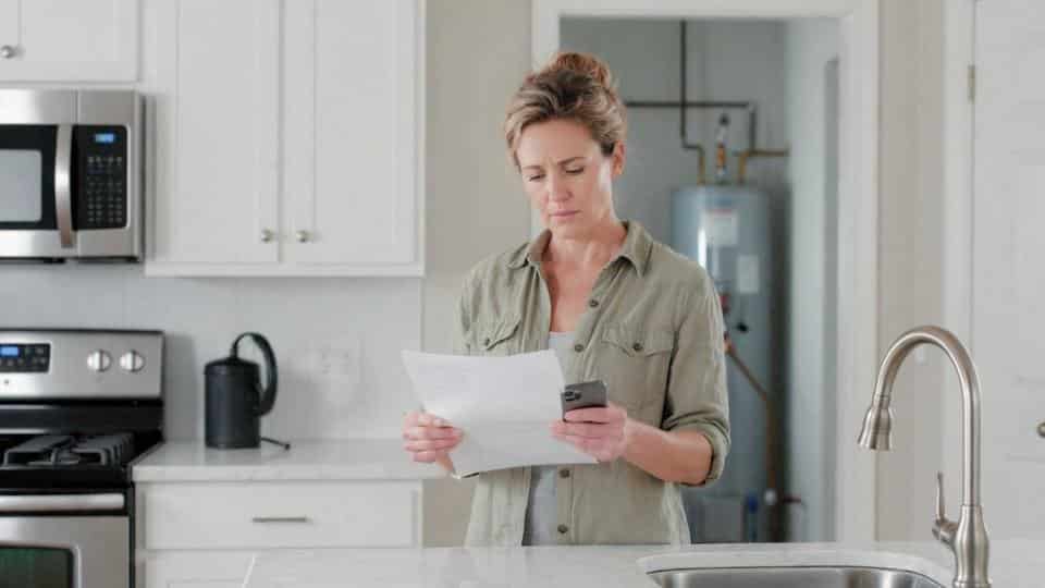 a homeowner evaluates an estimate of her new water heater cost