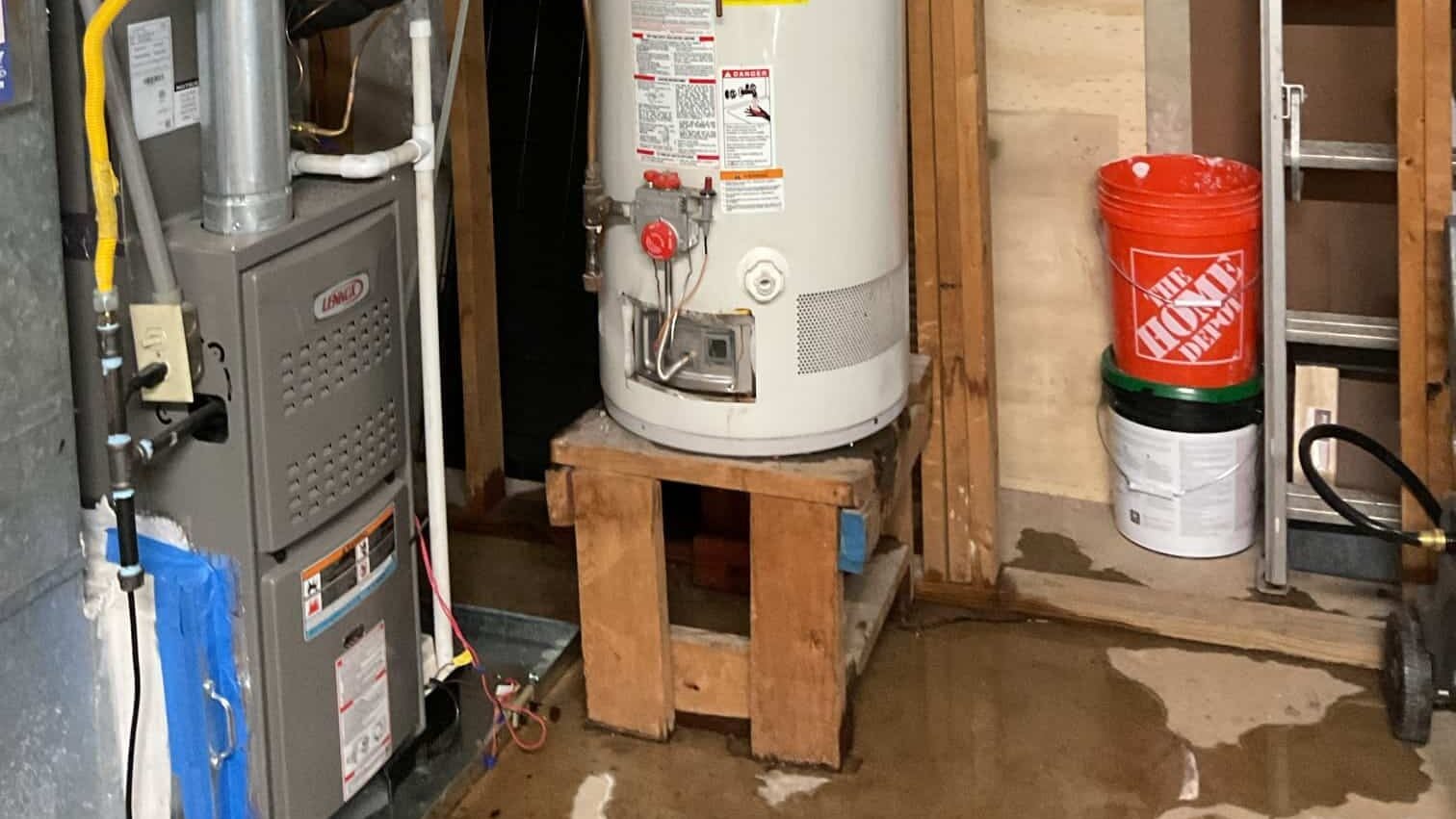 Leaking water heater in a Lawrenceville home during a plumbing emergency