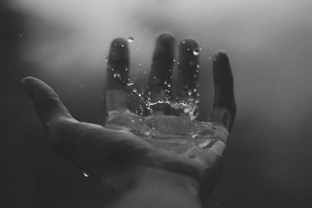 Water dripping into a hand