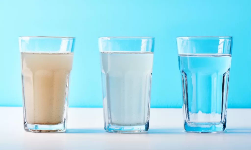 glass of dirty water cleaned with water filtration