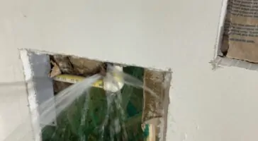 A frozen burst pipe leaking into the home
